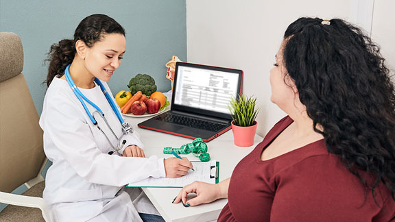 Female patient discussing weight management with female physician.